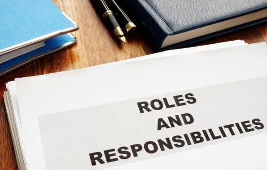 Roles and Responsibilities documents on a desk.